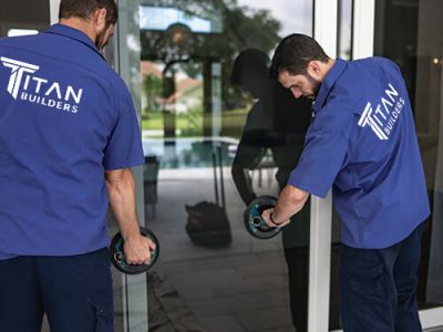 Titan employees installing a window